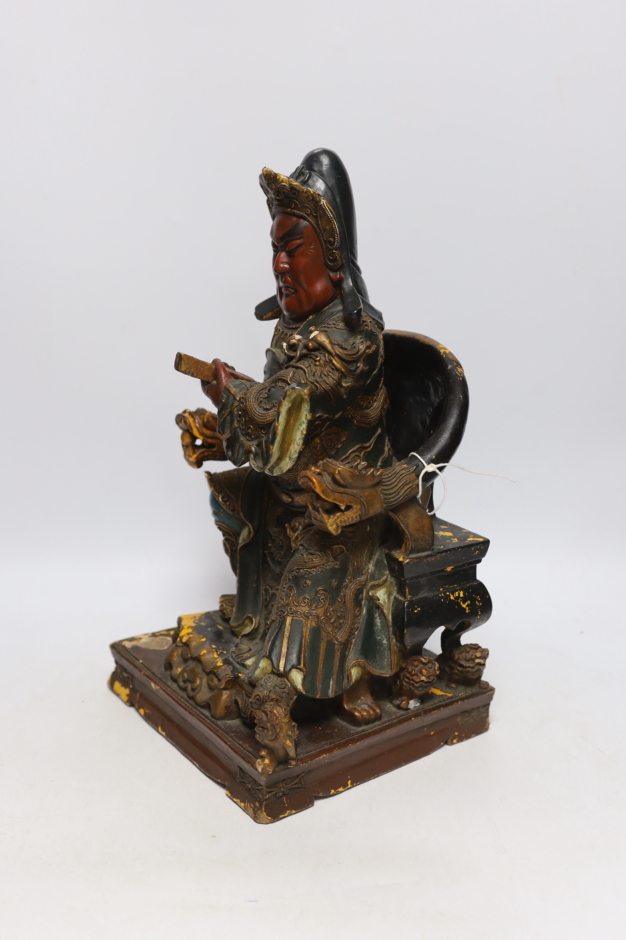 A 19th century Chinese polychrome wood and composition seated figure of Guandi, 41cm high